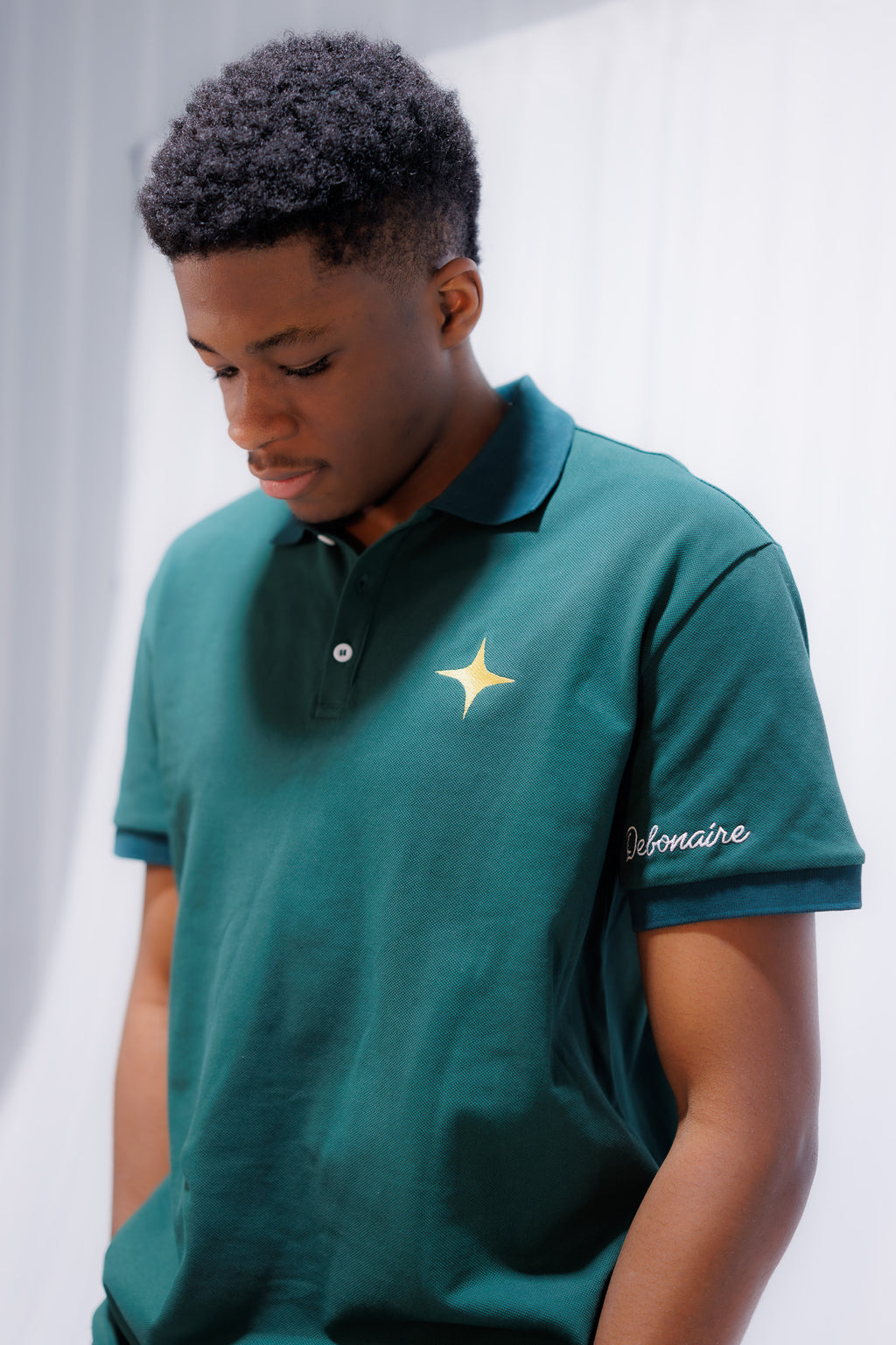 Debonaire Gentlemen’s Piqué Polo shirt in navy with a classic collar and short sleeves, displayed on a hanger.